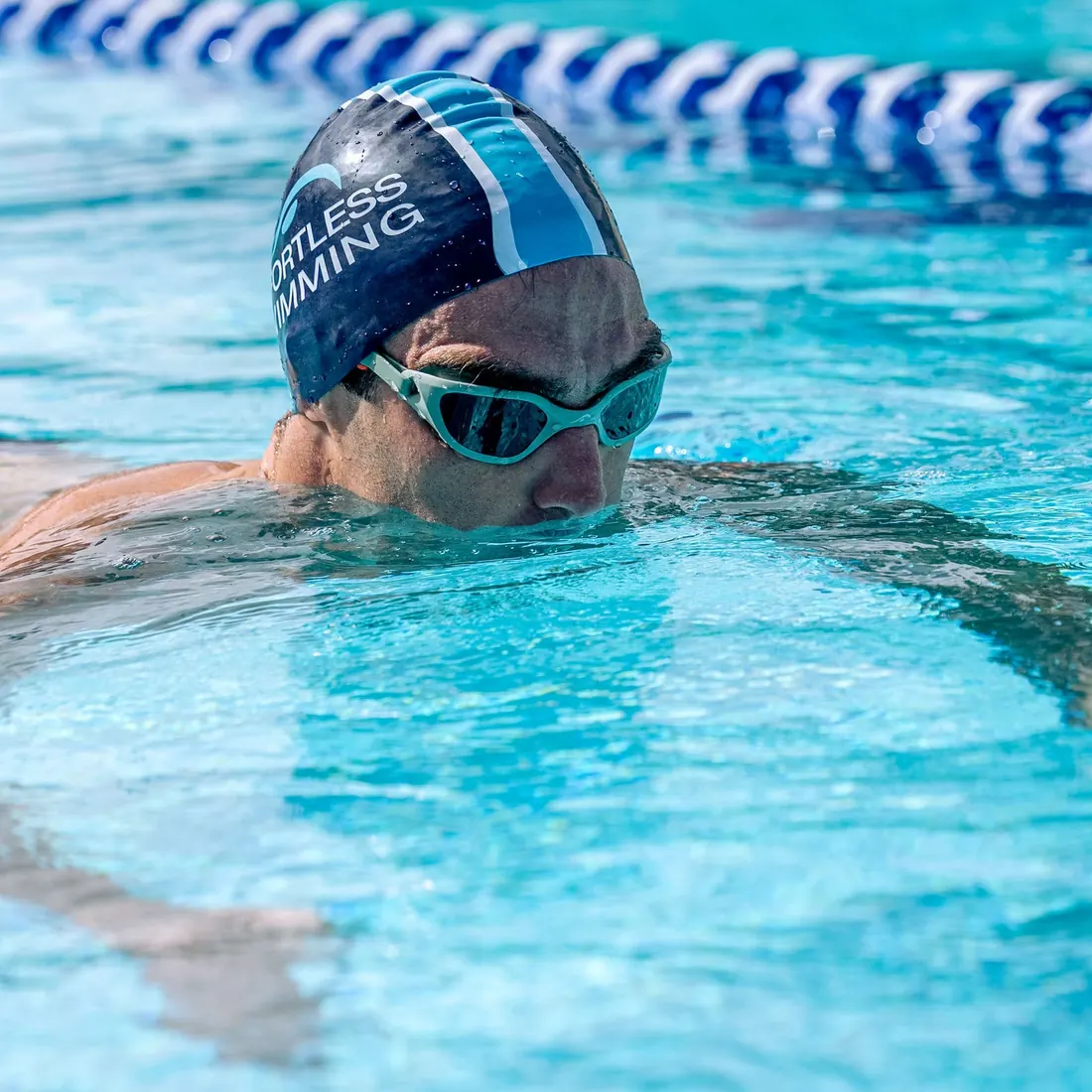 Swimmer doing freestyle in NanoClear Flex goggles