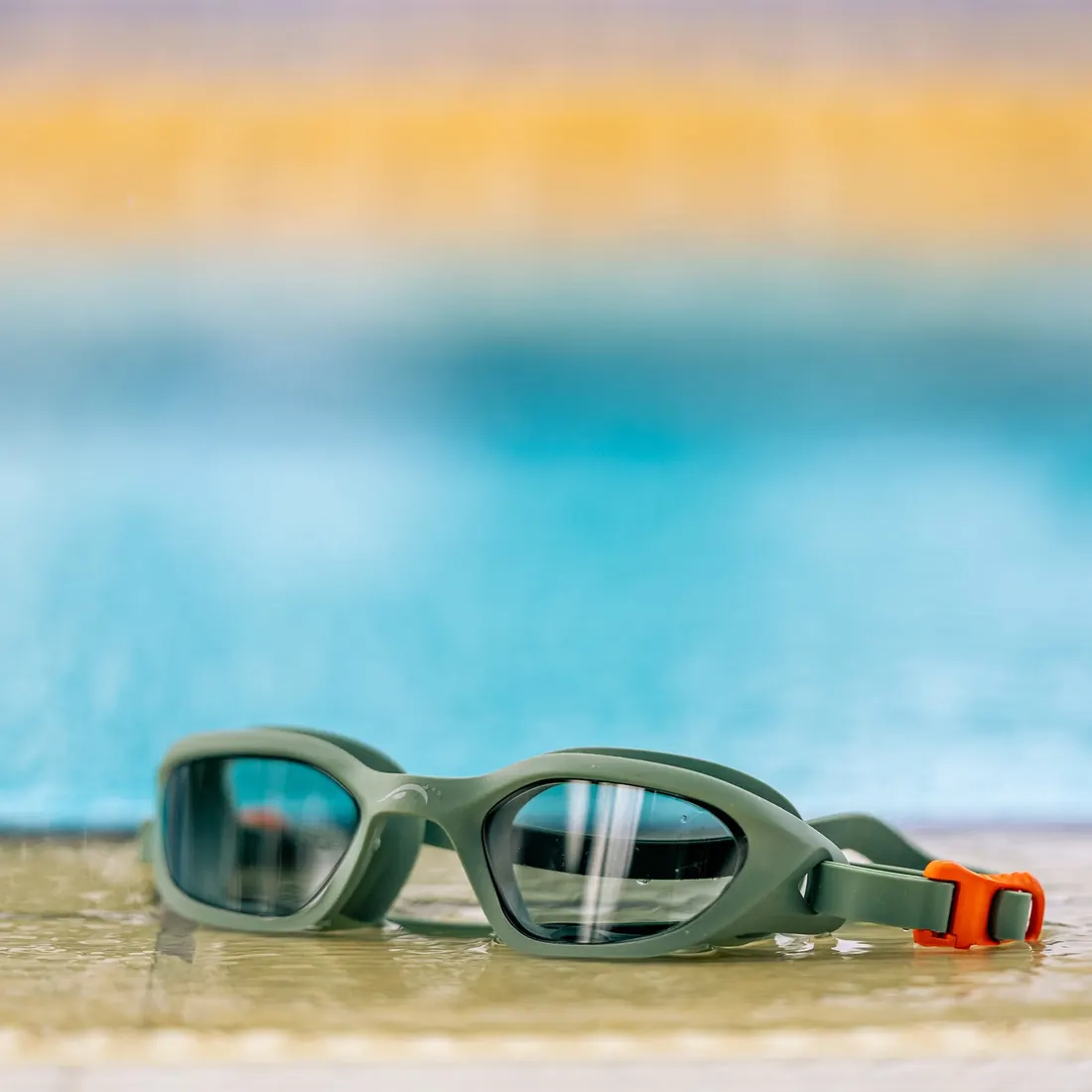 NanoClear Flex swim goggles, Smoke Green, on the pool deck